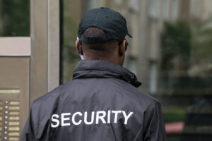 Rear View Of A Male Security Guard Wearing Black Uniform