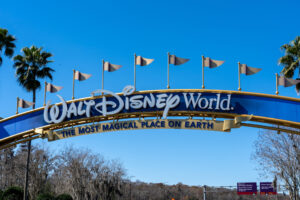 Orlando, Florida, USA - February 9, 2022:  A Walt Disney World arch gate on the road in Orlando, Florida, USA. Walt Disney World is an entertainment resort complex.